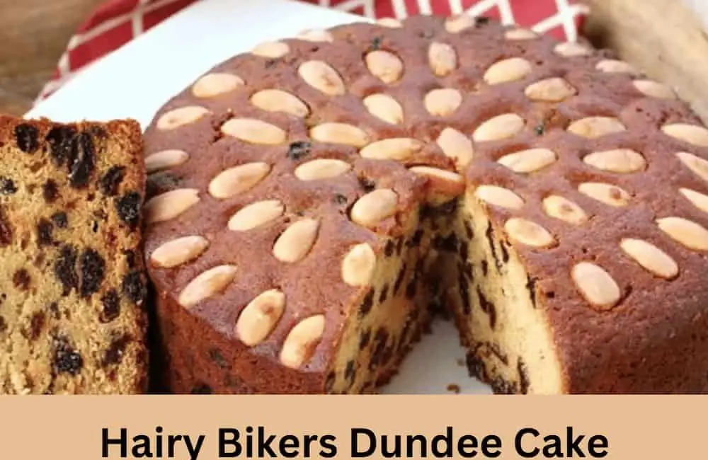 Traditional Christmas Dundee cake with dried fruits and almonds on a wooden  board. Festive dessert. Rustic style, selective focus Stock Photo | Adobe  Stock